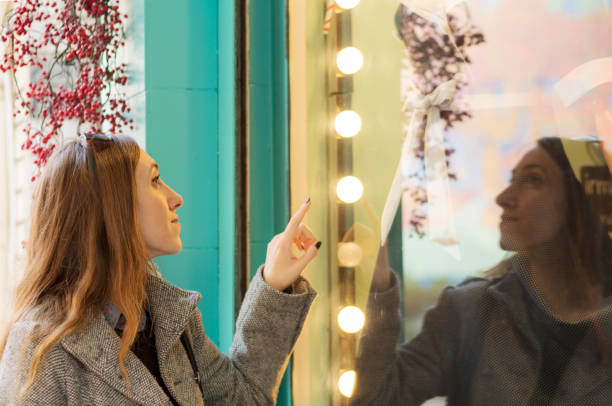 istock Woman looking at store window 941028638