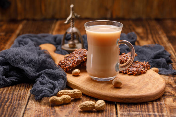 istock Tea with milk and cookies in glass cup on a beautiful board. Still life with tea, biscuits, nuts and an antique walnut. 941032650