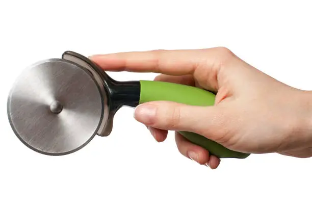 Photo of Hand with green pizza cutter isolated on white background