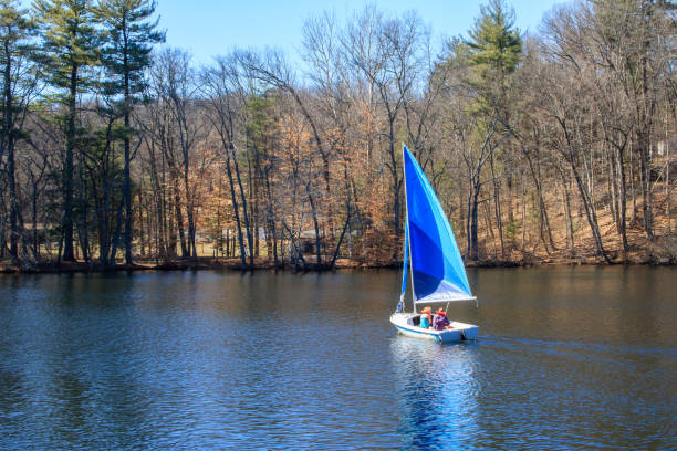 Windsor, Connecticut, USA - March 31, 2018: A couple enjoys an early spring day by sailing on Rainbow Reservoir stock photo