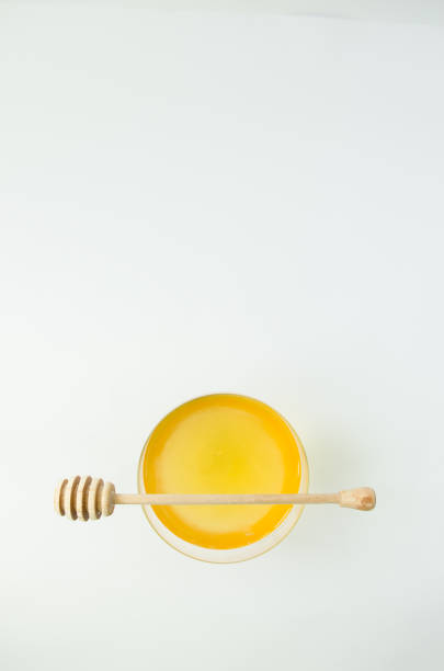istock Honey natural with a wooden spoon on a white background 941039752