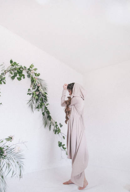 istock Young woman posing with flowers 941039796