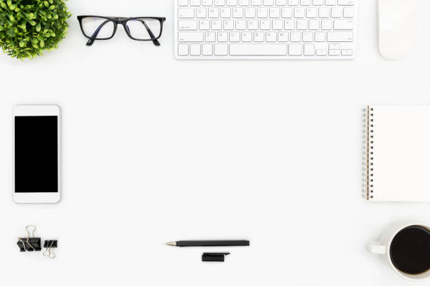 istock White hipster office desk table with computer gadgets, and supplies. Top view with copy space, flat lay. 941043488