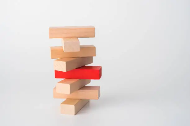 Wood block unstable staking. Business risk concept metaphor.