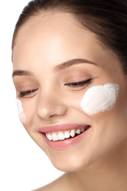 istock girl with cream on her face 941044086