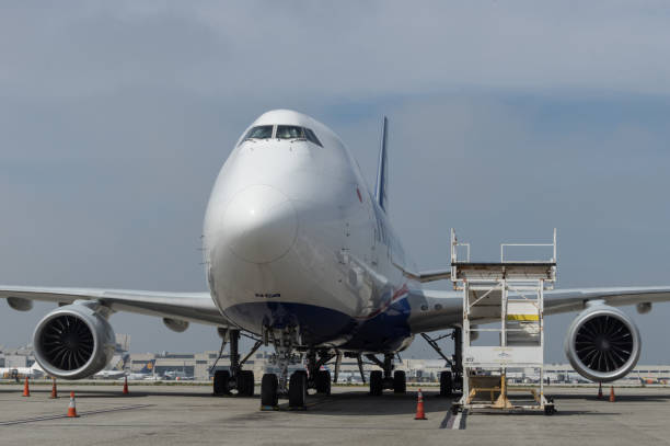 Nippon Cargo Airlines jumbo jet idle. Nippon Cargo Airlines, NCA, Boeing 747 shown parked at the Los Angeles International Airport. nippon cargo airlines photos stock pictures, royalty-free photos & images