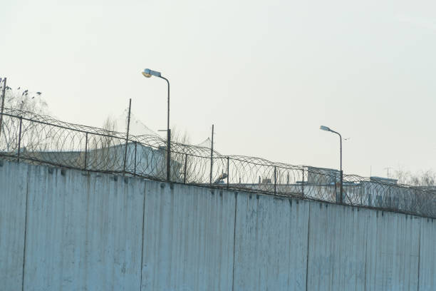 istock Fence with barbed wire, place of detention 941044658