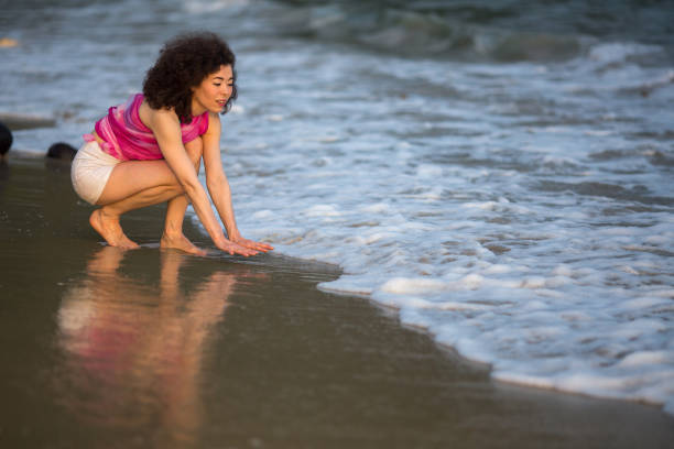istock Young mixed race woman on the sea beach. 941047498