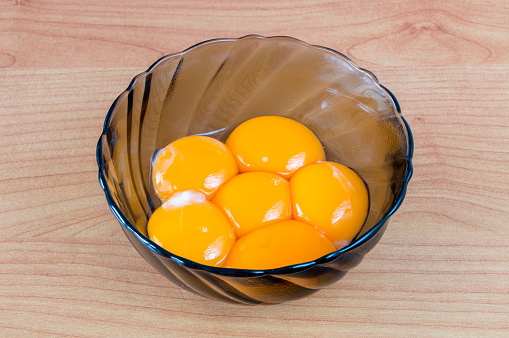 Five egg yolk at duralex bowl.