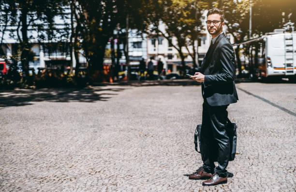 istock Man entrepreneur with smartphone on a sunny street 941047652
