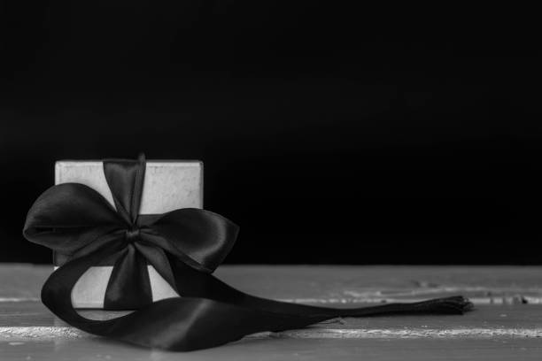 istock white  small gift box on white wood table with white and black effect 941051410