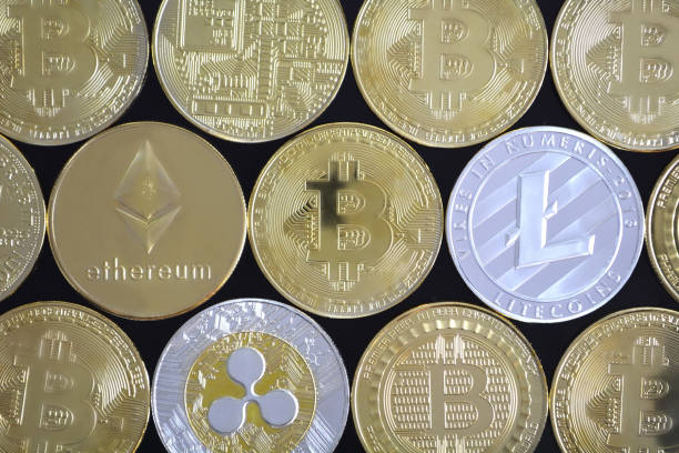 Cryptocurrency background. Toronto, Ontario, Canada - March 20, 2018 Studio Shot. Cryptocurrency background, new digital money Bitcoin, Litecoin, Ethereum, Ripple. Gold and silver. litecoin stock pictures, royalty-free photos & images