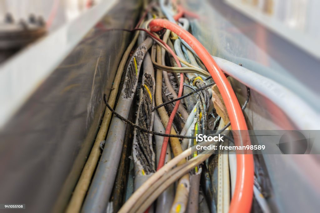 The cord is damaged. The cord is damaged because it isbitten by the mouse,causing danger. Cable Stock Photo