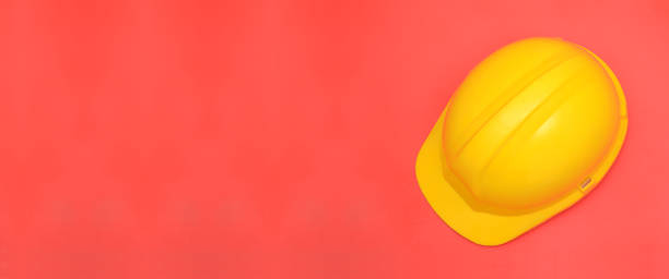 istock Yellow safety helmet on pink banner template 941055238