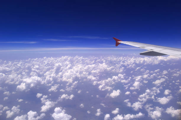 istock Airplane wing with beautiful cloud and blue sky on background, Amazing view from airplane window 941055450