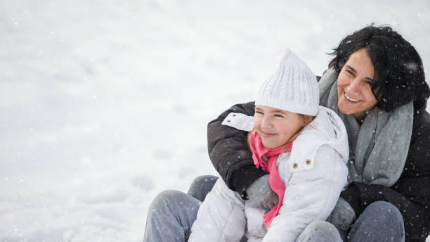 istock Mother and her daughter enjoying in snow 941061938