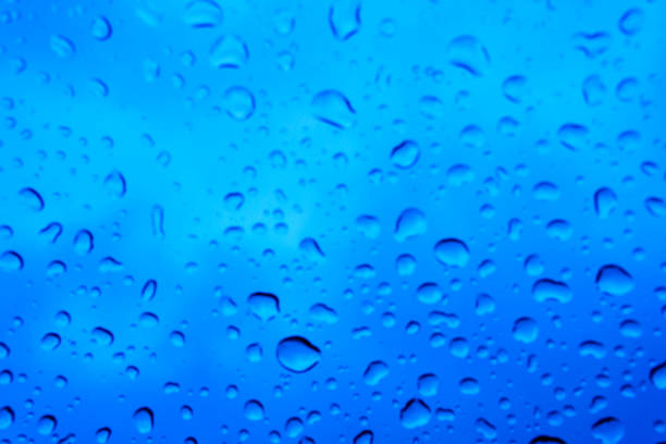 istock blurred beautiful drop of rain on glass or windows surface. blurred dew or raindrop on glass surface for abstract background. 941062302