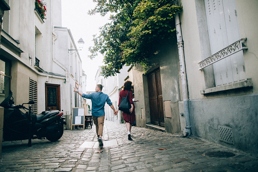 Portrait of young lovely caucasian couple resting in Paris, France.