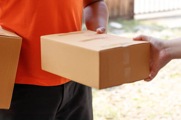istock Customer signing document and receiving the parcel from delivery man. 941065984