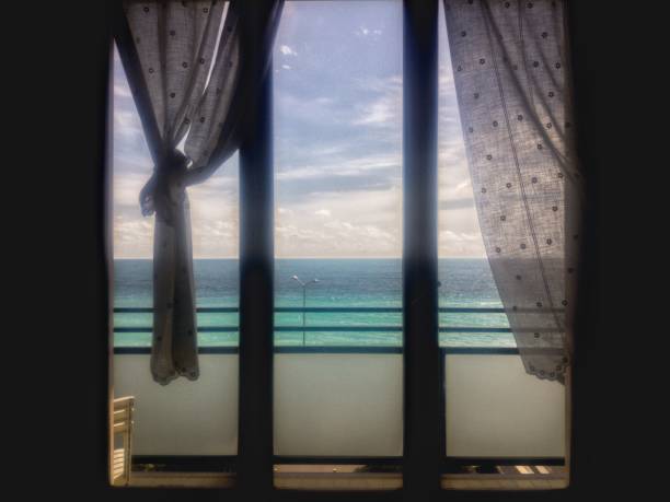 istock Looking the sea trough the window 941068004