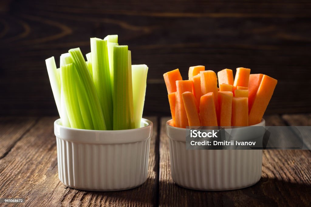 The sticks of carrots and celery. The sticks of carrots and celery on wooden table. Celery Stock Photo