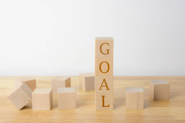 istock Woodens cubes on table and cement wall background - GOAL 941072292