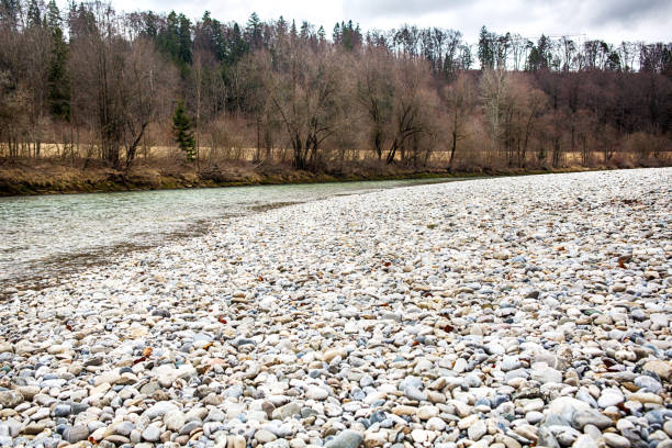 bavarian landscape with river, forest and rocky riverbank