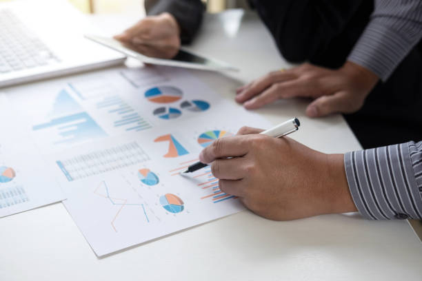 istock Teamwork process, Business adviser analyzing financial figures denoting the progress in the work of the company 941073378