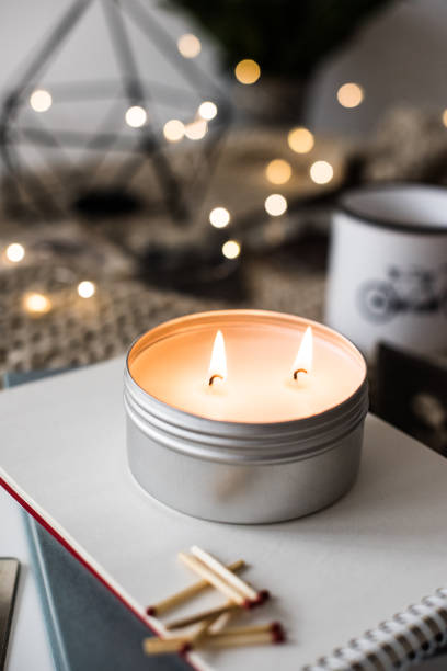 istock Cozy warm home decoration with burning candle and bokeh lights 941075790