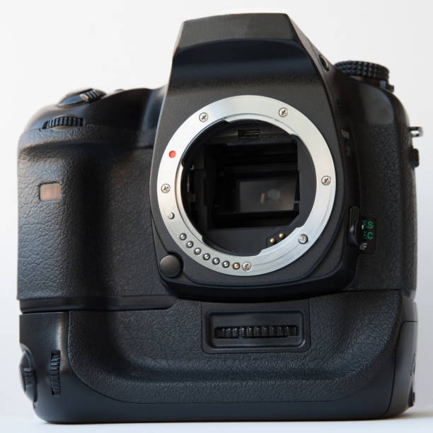 Digital SLR camera with vertical battery grip over white background