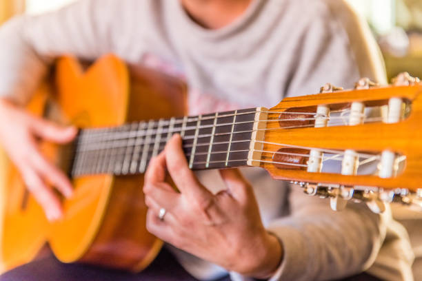 istock woman playing spanish guitar 941076316