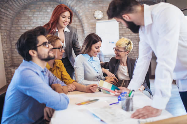 istock Business people working in office together. Team work in office. 941076734