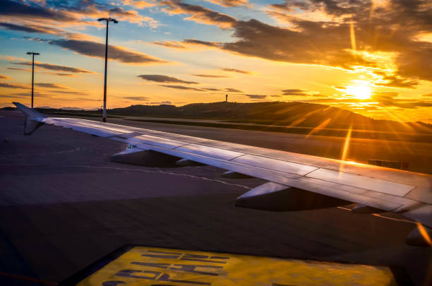 istock The wing of the plane while has been landed with beautiful sunrise light. 941081470