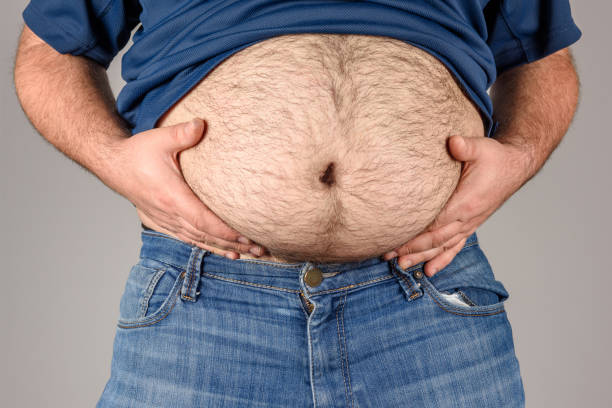 Overweight, Hairy Man's Belly Overweight, Hairy Man's Belly high quality and high resolution studio shoot hairy fat man pictures stock pictures, royalty-free photos & images