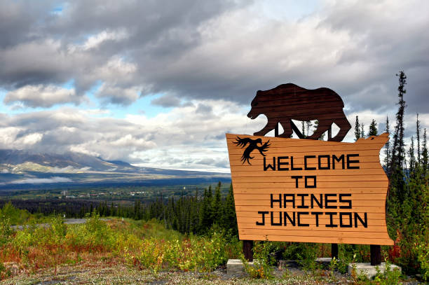 Haines Junction,Canada - August 30, 2005: Welcome  panel with carved wooden bear seen along the road when arriving in the small village of Haines Junction, the gateway to the Kluane National Park in Yukon