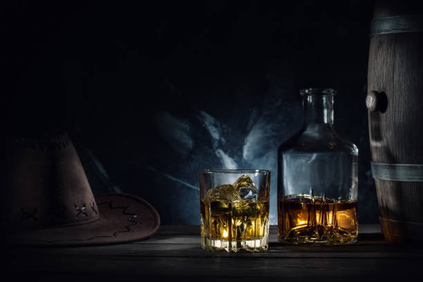 Whiskey and hat and barrel on dark background stock photo