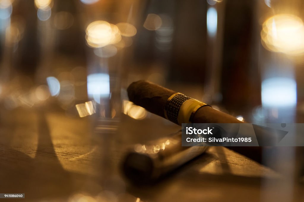 Close up of cigars on bar table with blurred background. Alcohol - Drink Stock Photo