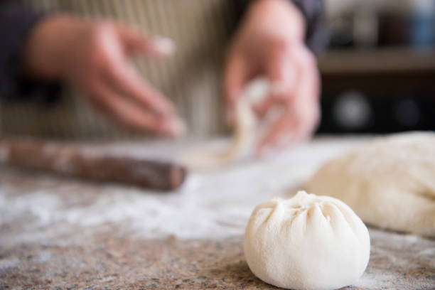 Hand Made Traditional Chinese Dumpling and Steamed Bun Hand Made Traditional Chinese Dumpling and Steamed Bun at home chinese ethnicity china restaurant eating stock pictures, royalty-free photos & images