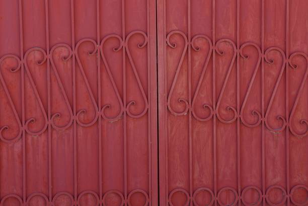 istock iron background from a steel forged pattern on a red metal fence 941090122