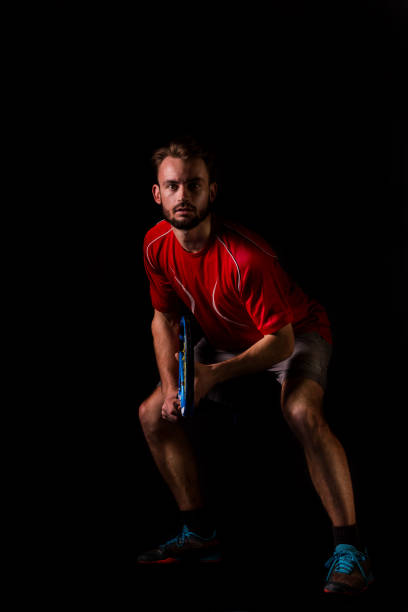 Photo of guy hold racket toothy beaming smile wear headband sportswear specs isolated violet background