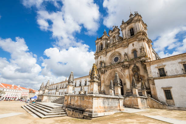 Alcobaca Monastery, Portugal Main facade of the Alcobaca Monastery (Mosteiro de Santa Maria) in Portugal, in gothic and baroque architecture. A World Heritage Site since 1997 alcobaca photos stock pictures, royalty-free photos & images