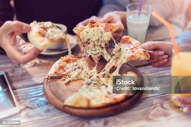 Closeup Of People Hands Taking Slices Of Pizza Stock Photo - Download Image Now - Pizza, Eating, Sharing
