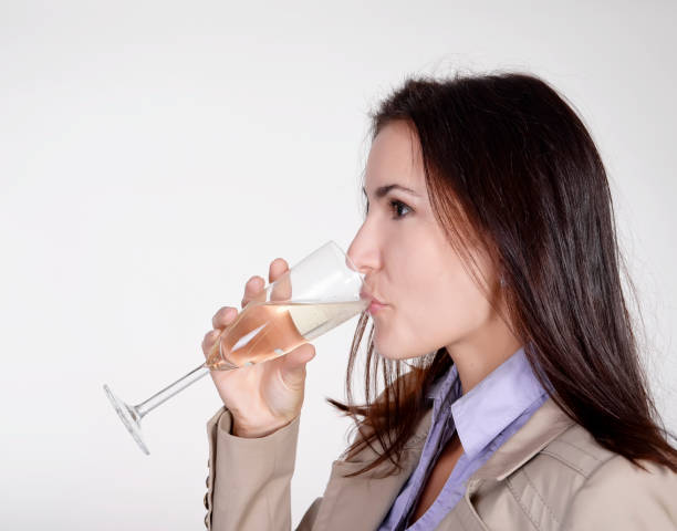 istock businesswoman drinking champagne 941108322