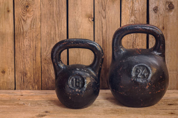 istock Pair of two old heavy iron kettlebells 941109260