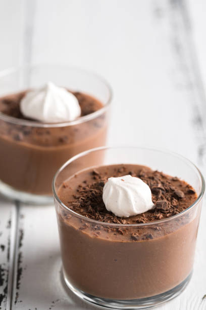 istock Chocolate mousse in a glasses on a white wood background. 941112770