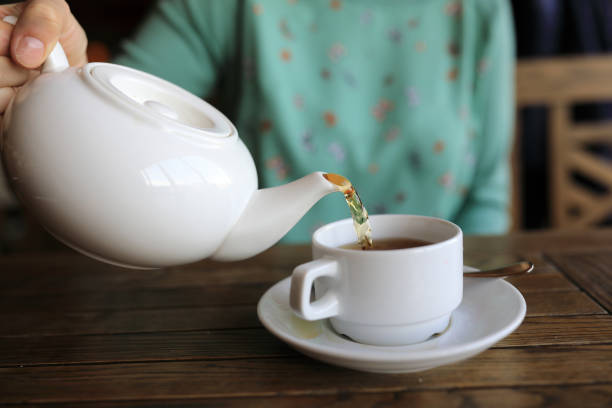 istock Woman pouring green tea 941113186