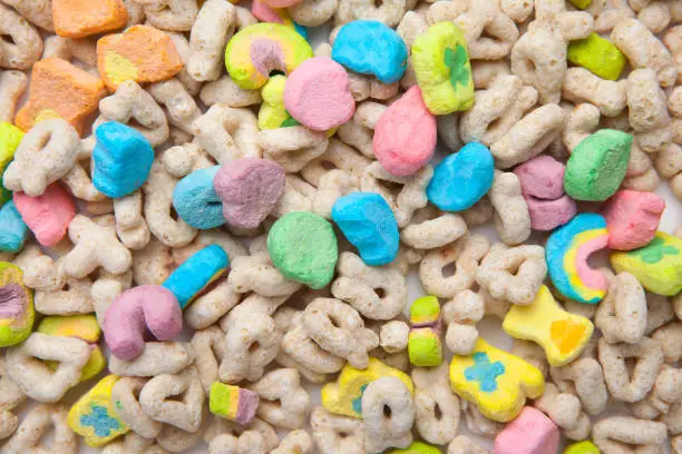 Photo of Frosted toasted oat cereal with fun shaped marshmallows on white background.