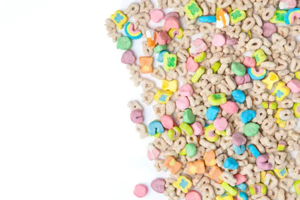 Photo of Frosted toasted oat cereal with fun shaped marshmallows on white background.