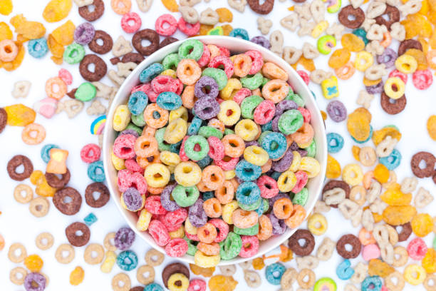 istock Bowl of colored cereals on white background 941115596