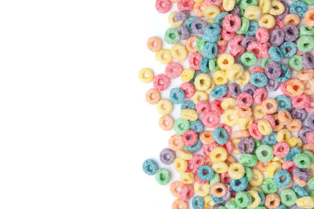 Multicolor cereals with fruity on white background. Blank space for texts.
